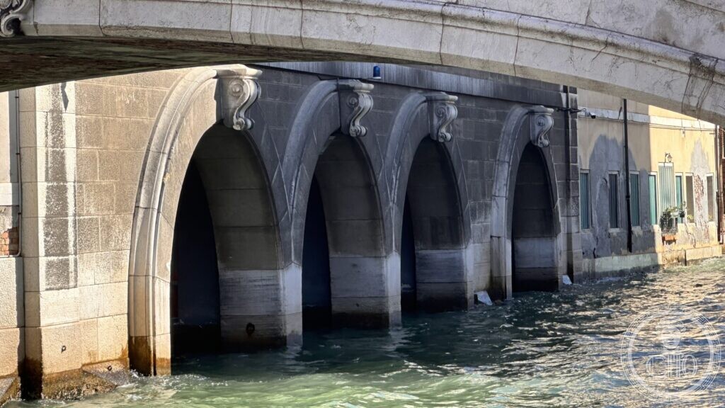 Close view of the four arched boat garages at water level under the fire station