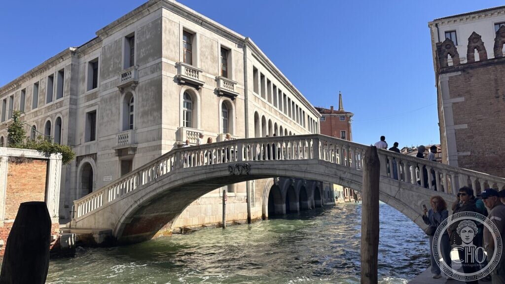 The canal front of the Venice fire station seen past a white stone bridge