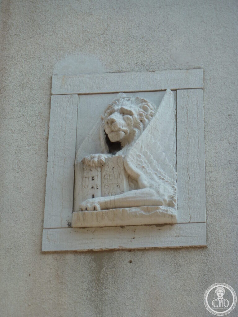 Detail of the upper floors of the fire station, plain stone with rectangular windows