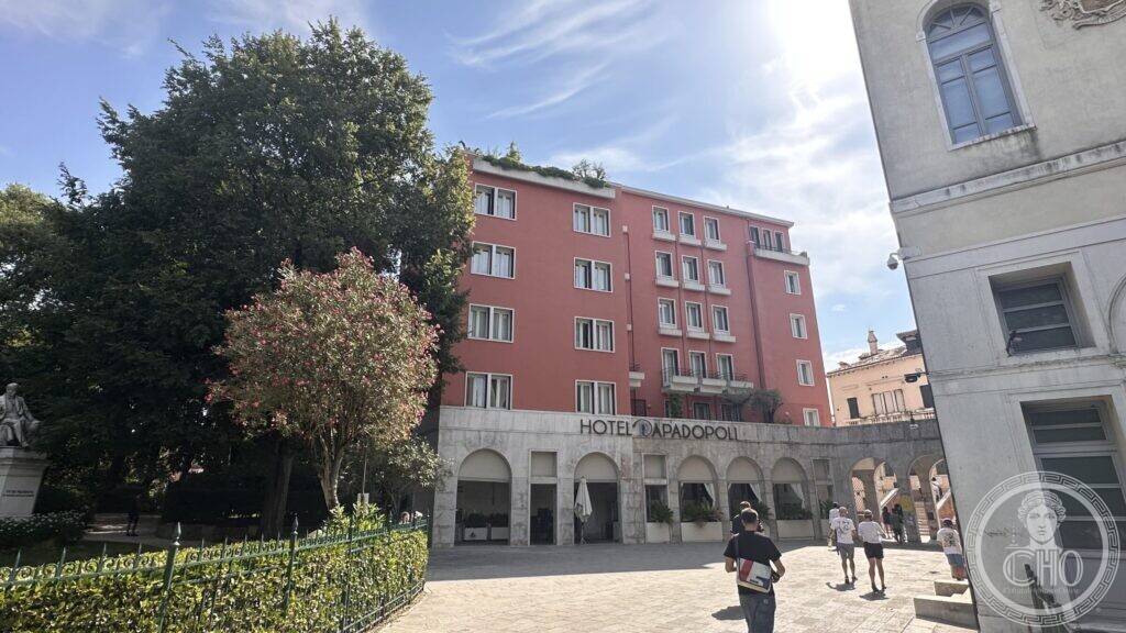 The Hotel Papadopoli seen from the Papadopoli gardens, with an oleander in flower and the monument to Pietro Paleocapa on the left