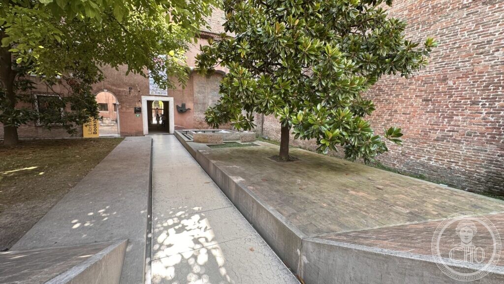 The concrete canopy of the Scarpa entrance seen from close up, cantilevered over the passage into the courtyard