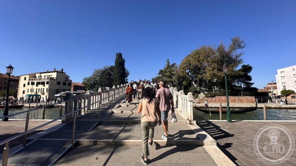 The deck of the Ponte Papadopoli with people crossing it