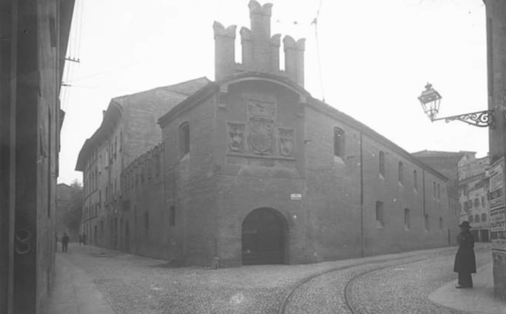 Historic black and white photograph of Via Collegio di Spagna in central Bologna around 1900