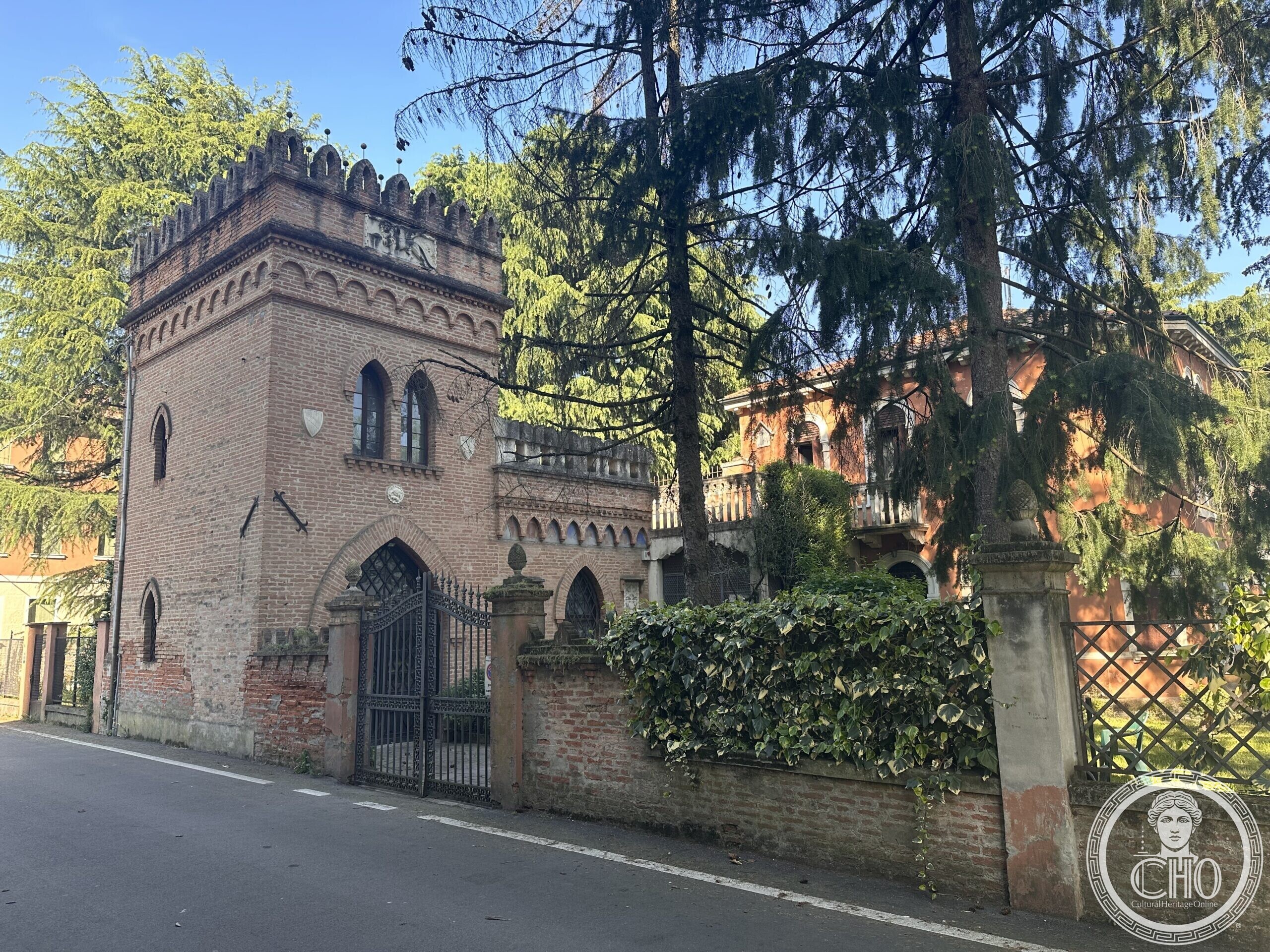Ochre-red Liberty-style villa with arched windows and a wrought-iron gate, Via Piave, Olme, Mogliano Veneto