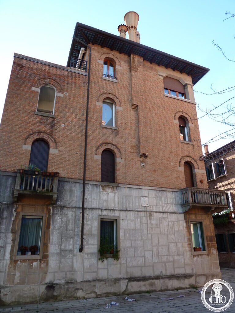 Detail of the brick facade, arched biforate and triforate windows and balcony of the villino at Campo Monte Grappa, Sant'Elena, Venice