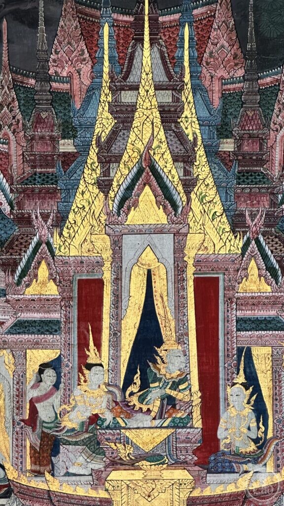A brightly preserved section of Wat Suthat mural showing a gilded celestial palace with tiered pink and green roofs and deities seated below it