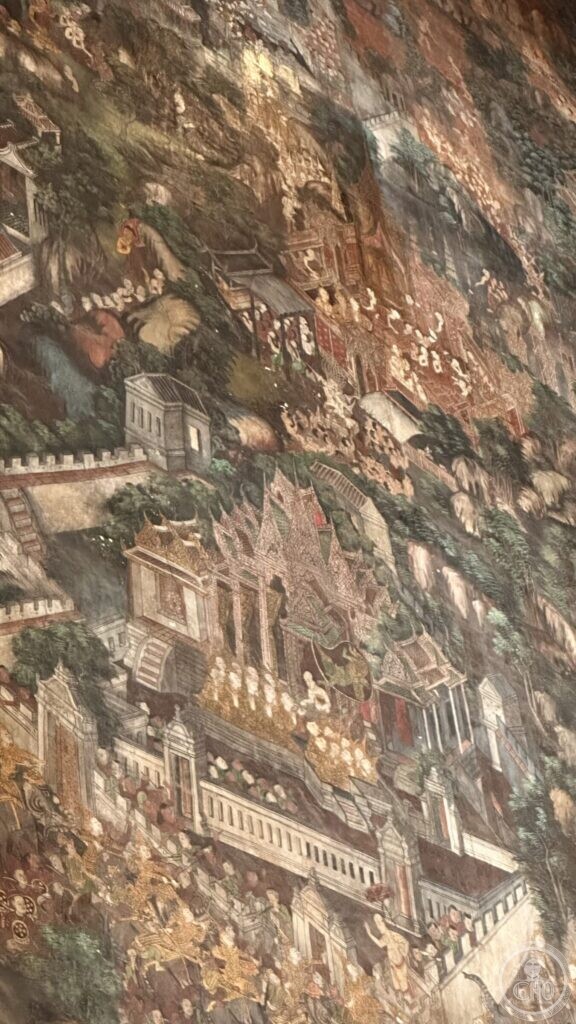 Detail of a Wat Suthat mural in which classical European-style buildings with pediments and balustrades stand among Thai temple roofs