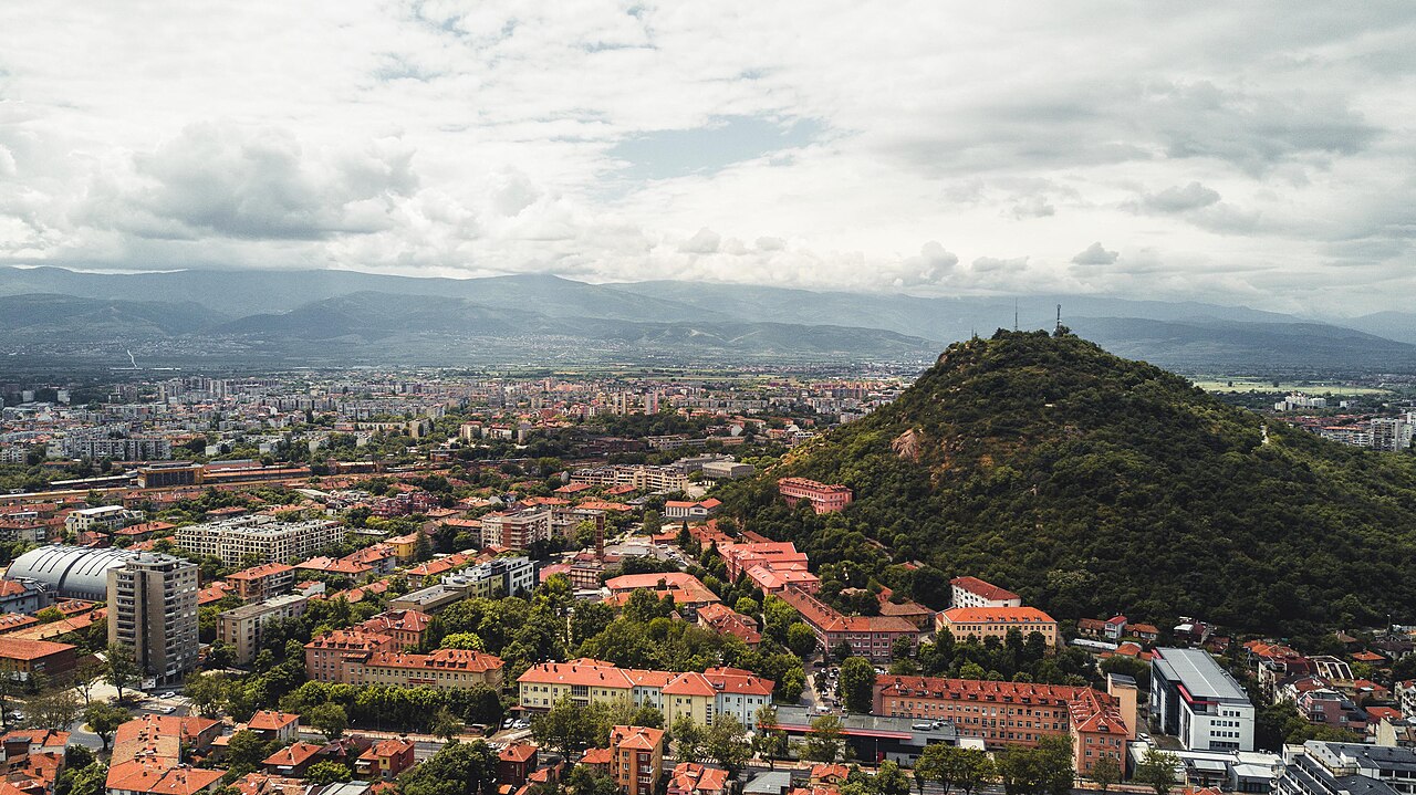 Aerial view of Plovdiv showing the Thracian hills (tepe), the Roman amphitheatre, and the National Revival old town quarter above the Maritsa river plain