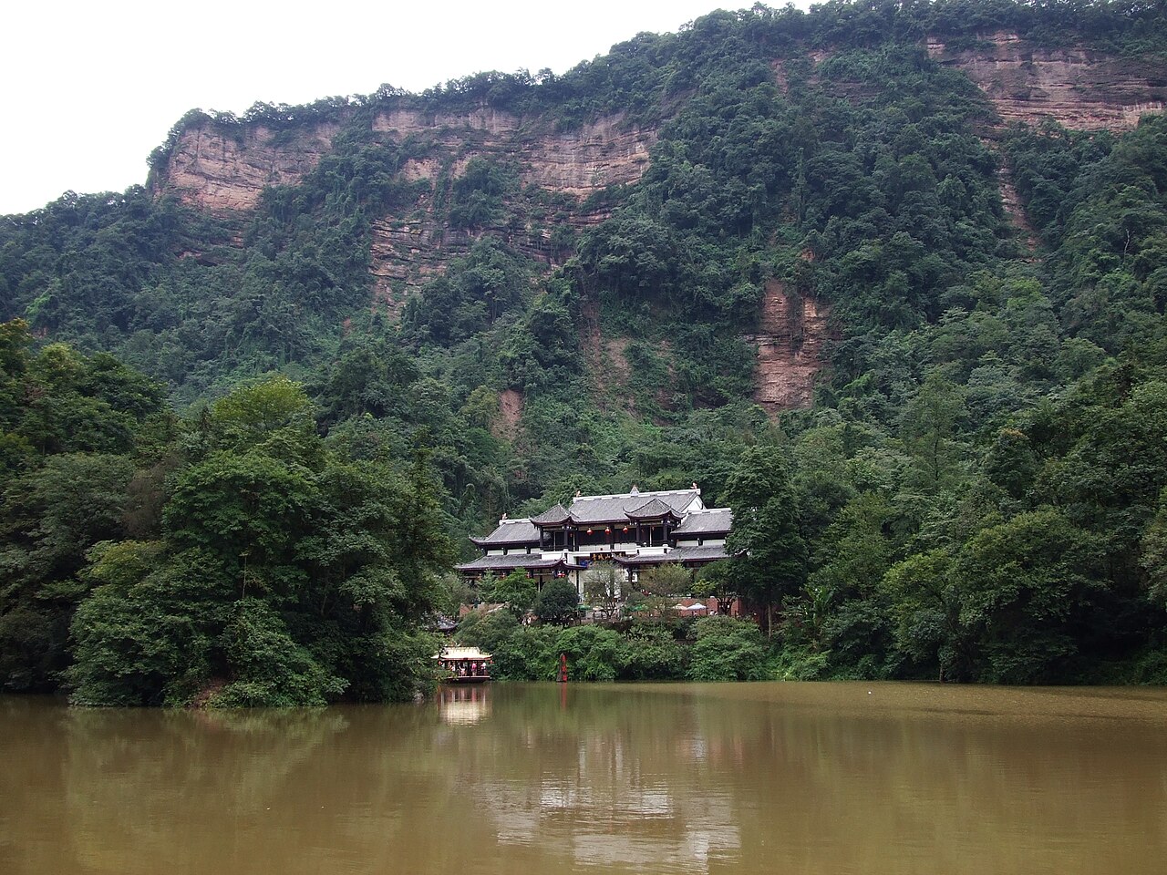 Forested slopes and Daoist temple buildings at the base of Mount Qingcheng, Sichuan Province, China