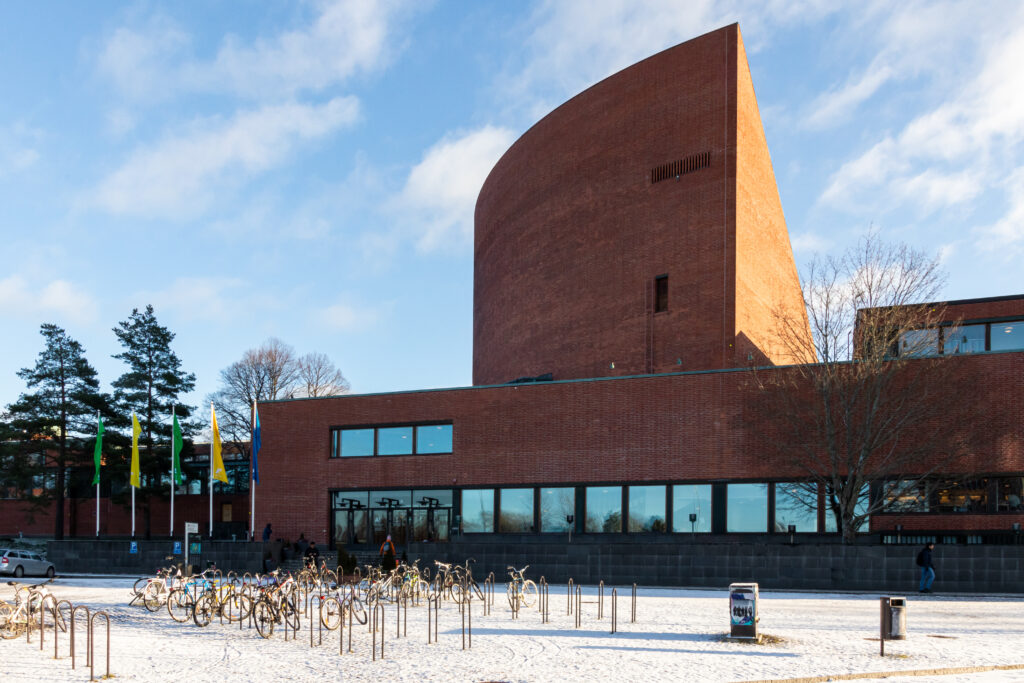 The Aalto University Undergraduate Centre at Otaniemi, with its fan-shaped stepped auditorium in dark red brick