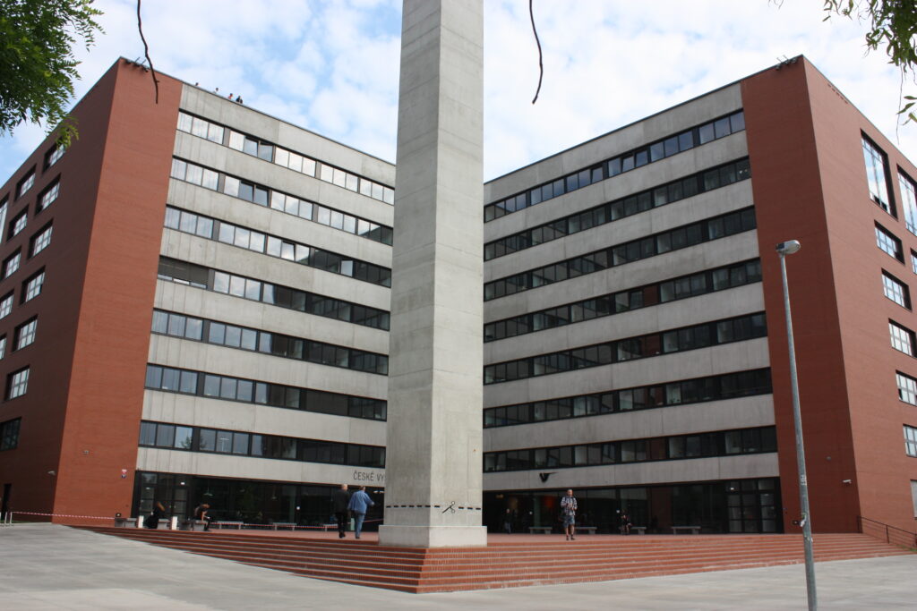 The Faculty of Architecture building at Dejvice, Prague, a brick-clad block with coloured lecture-hall volumes projecting from it