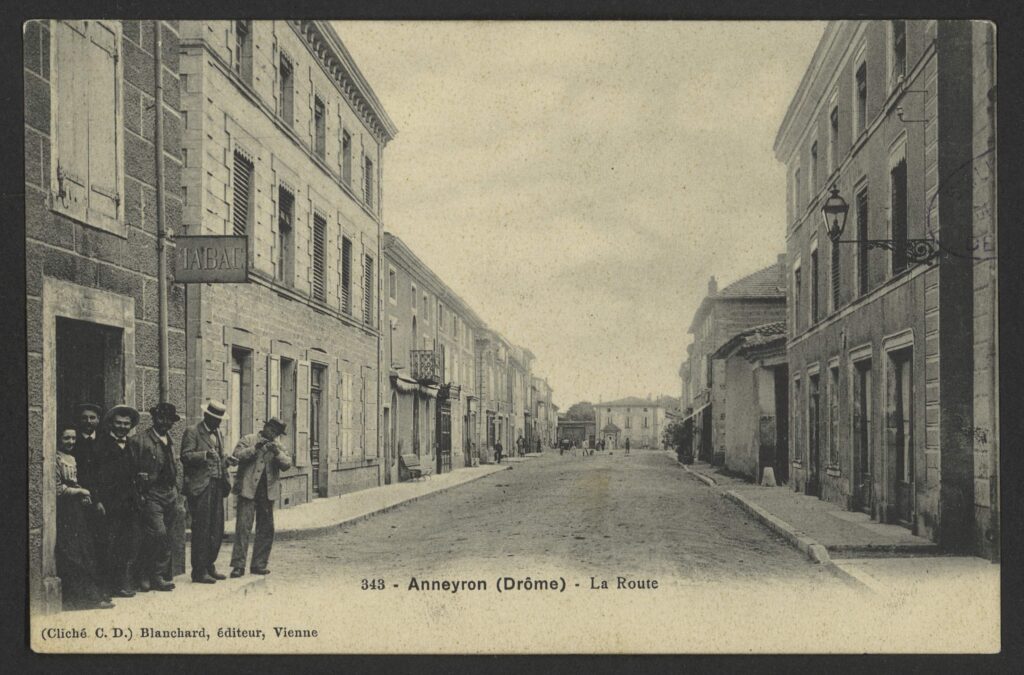 Archival postcard view of the historic thoroughfare and workshop district in Anneyron