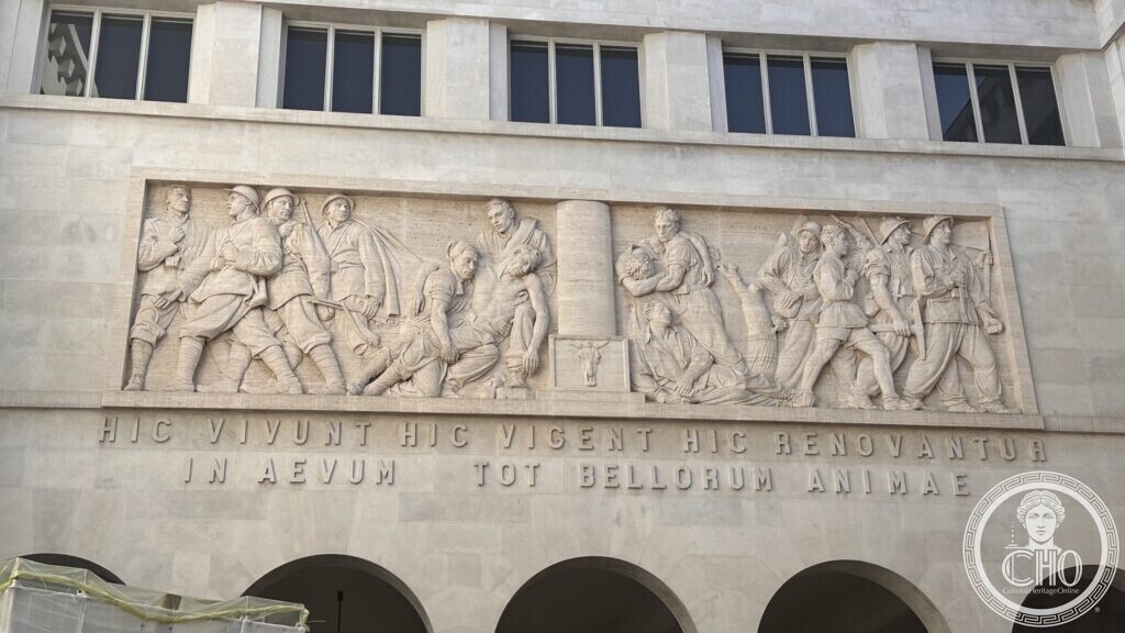 A close view of the marble relief depicting soldiers and a fallen figure