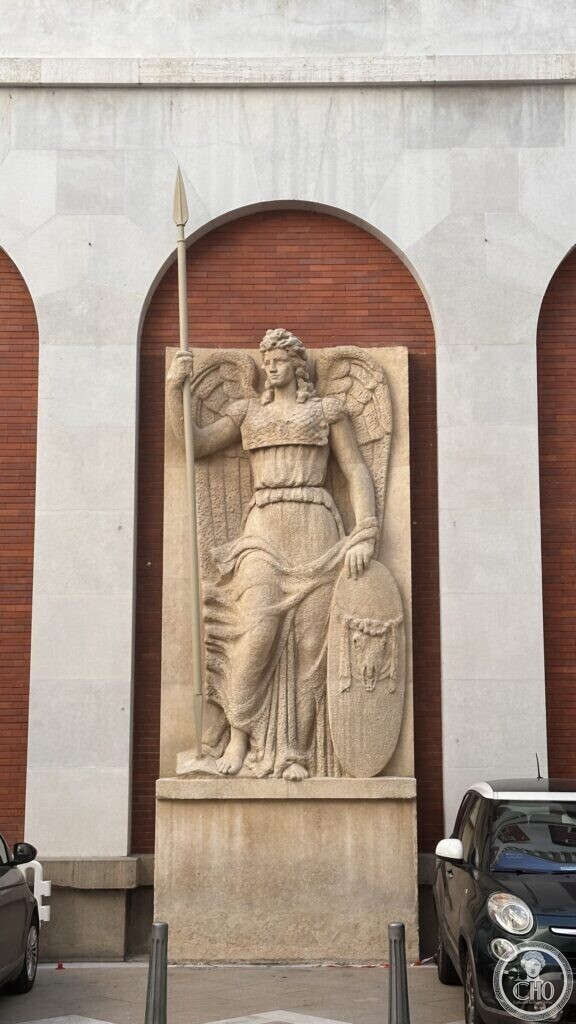 A statue of a winged female figure holding a spear and shield