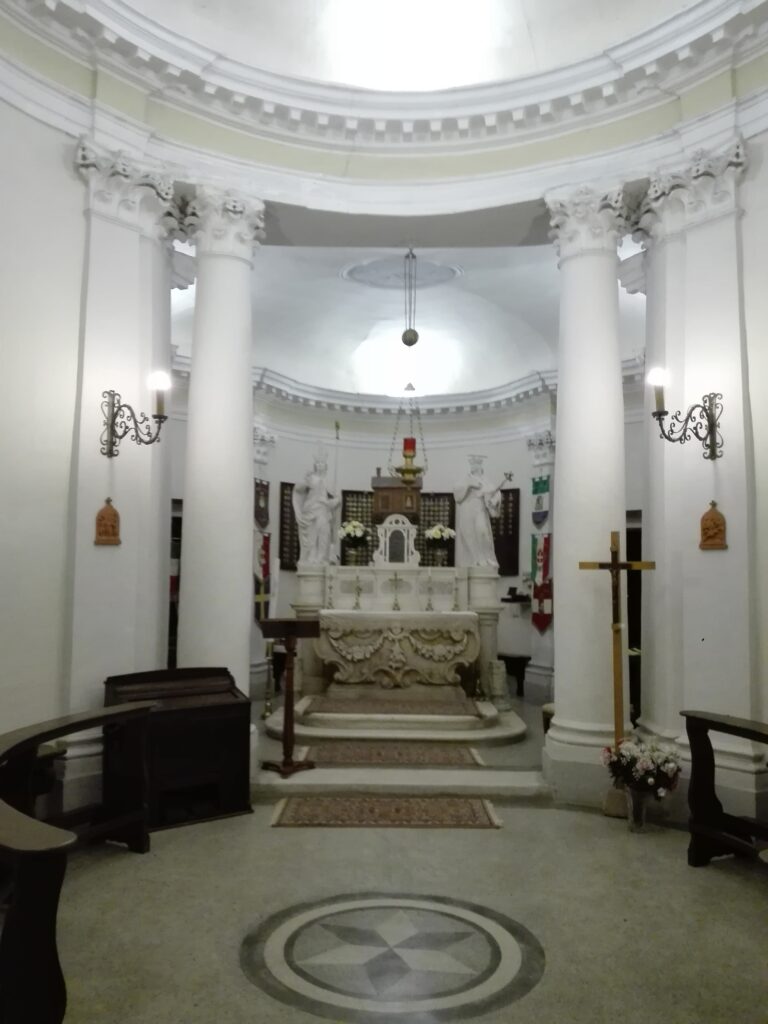 The oratory of Villa Loredan at Carbonera: a small plastered chapel with a pedimented front and a round window above the door, seen among trees